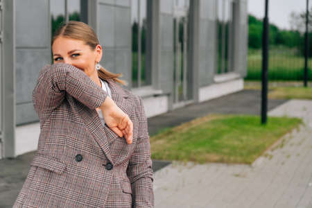 Runny nose and sneezing on the street, social distance from infected patients.の写真素材