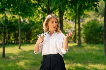 Portrait of a stylish woman holding a purse , the concept of a failed purchase . Robbery at a time of crisisの写真素材