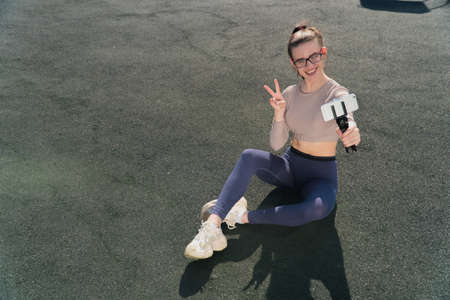 cheerful caucasian girl blogger talking to camera, filming educational video blog, webinar, blonde...
