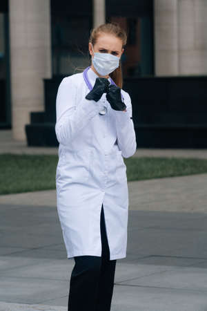 A portrait of a doctors girl wearing a medical mask shows a sign of prohibitionの写真素材