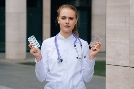 The young doctors girlfriend is holding pills in her hands.の写真素材