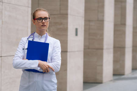 doctor woman holds folder with documents in her handsの写真素材