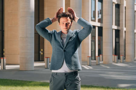 man covered his face with his hand in his palm, surprised apartment specialistの写真素材