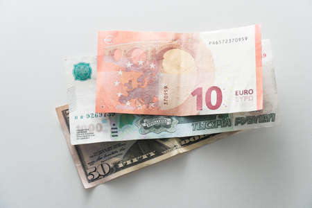 Banknotes of different countries of the world close-up on the tableの写真素材