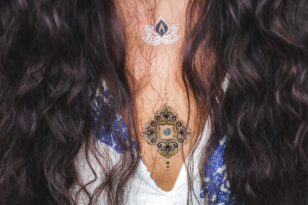 Girl with gold flash tattoo and long black hairの写真素材