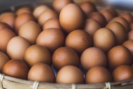 Wicker basket with fresh eggsの写真素材