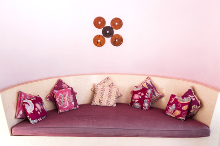 Wooden vintage furniture with handmade colorful pillowsの写真素材