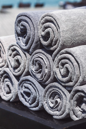 Stack of rolled towels in hotel near beachの写真素材