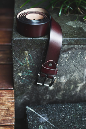 Groom wedding details. Leather belt on stone backgroundの写真素材