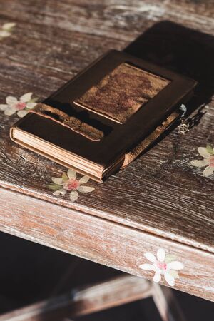 Vintage notebook with leather cover on the wooden tableの写真素材