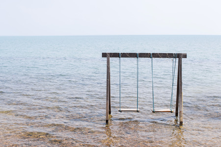 Swing above the sea on the beach