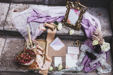 Beautiful wedding details with fresh grape, silk, frame and invitationの写真素材