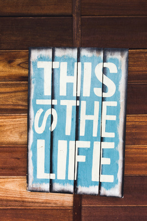 Wooden plate with sign This Is The Lifeの写真素材