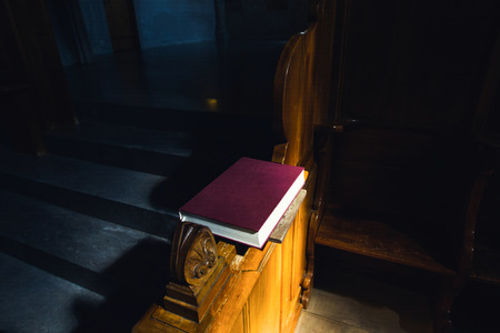 Bible in the church illuminated sun beamの写真素材