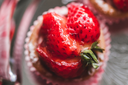 Delicious cupcakes with fresh strawberries, raspberries and blueberries
