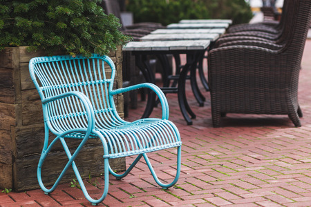 Design vintage furniture of the restaurant outdoor. Blue wicker chair and wooden tableの写真素材