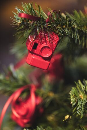 Christmas tree decorated with small figures of red photo camerasの写真素材