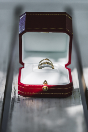 Wedding rings in a red gift boxの写真素材