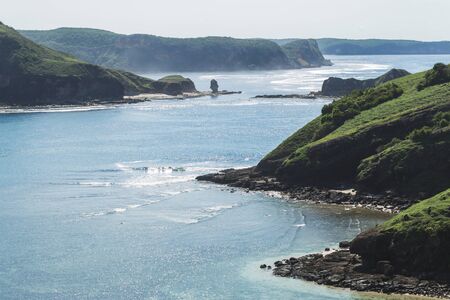 Paradise tropical island landscape with clean and transparent water and hilly shore to horizonの写真素材