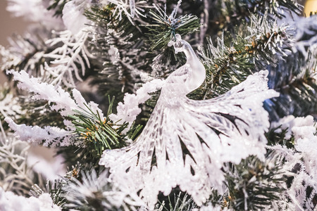 Transparent glass ornaments on a Christmas tree figure of a peacock birdの写真素材
