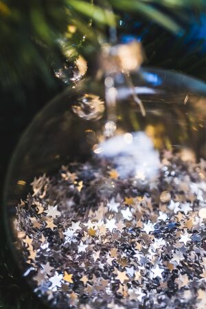 Christmas ball close-up with a lot small shiny stars insideの写真素材