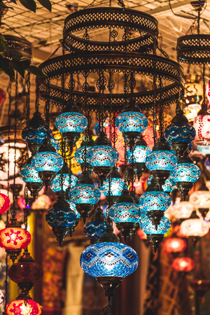 Amazing traditional handmade turkish lamps in souvenir shop. Mosaic of colored glass. Lit in the evening, creating a cozy atmosphereの写真素材