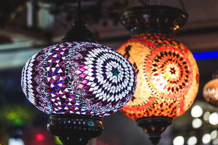 Amazing traditional handmade turkish lamps in souvenir shop. Mosaic of colored glass. Lit in the...