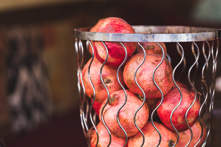 Fresh pomegranates in a basketの写真素材