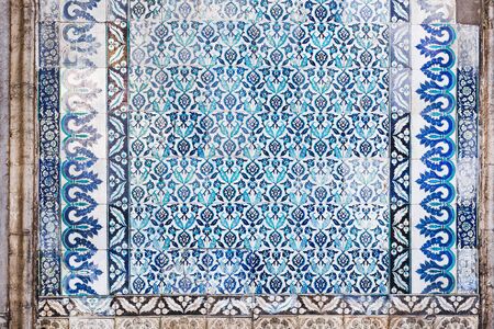 Seamless pattern white Turkish tiles with blue ornaments. Old surface texture, wall in mosque