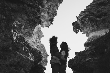 Photoshoot couple in the mountains at sunset. Silhouette together