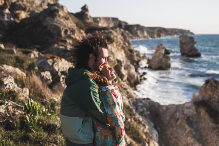 Love story on Tarhankut coast in Crimea. Young couple in love at sunsetの写真素材