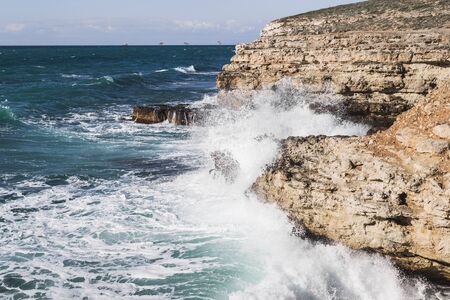 Coast Tarhankut in Crimea. Big waves breaking on the rocky coastの写真素材