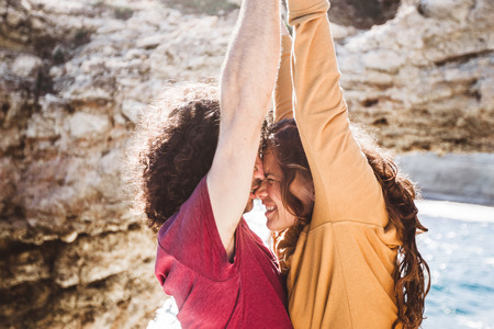 Lovely couple having fun in sunlight. Long curly hair, happiness and pleasureの写真素材