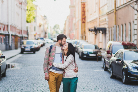 Young couple in casual style walking on city streets in old Saint-Peterspurg. Cheerful and happyの写真素材
