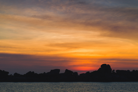Bright red sunset at tropical island coast in Indian Oceanの写真素材