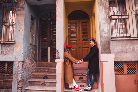 Happy couple in love on the background of old colorful painted facade. Old streets of Istanbul in Balatの写真素材