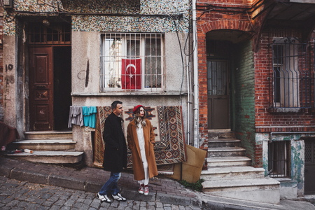 Couple standing on the background of old carpet. Old streets of Istanbulの写真素材