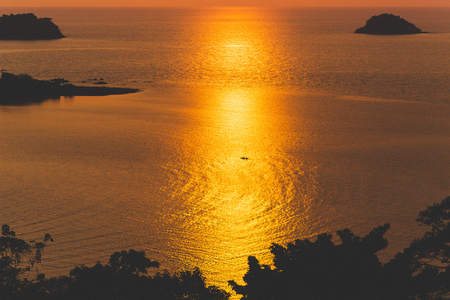 Amazing colorful red sunset at tropical islands. Silhouettes in sunlight, space fot textの写真素材
