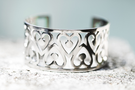 Silver bracelet with hearts ornament close-up. Wedding accessoryの写真素材