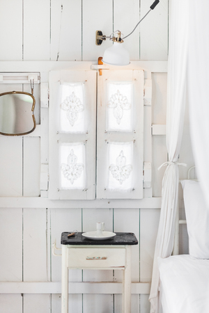 interior of light modern wooden house inside, vintage window with shutters and decorative curtains. Rustic and village styleの写真素材