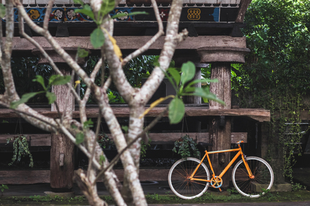 Old fixie bicycle as decoration of hotel in village rustic style in Bali tropical natureの写真素材