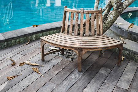 Wooden bench near swimming pool in luxury resort. Wooden floorの写真素材
