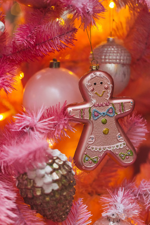 Unusual artificial Christmas tree decoration on pink fir branches, cute glass handmade toys. New Year Decorの写真素材