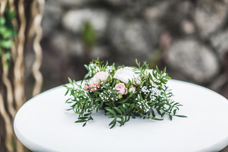 White wedding table decorated with green flowers arrangement, name cards, pink peony, white cutlery, rustic styleの写真素材