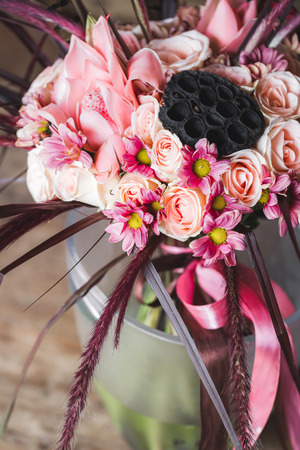 Wedding bouquet in Boho style with pink silk ribbons, roses, chrysanthemum and tropical plantsの写真素材