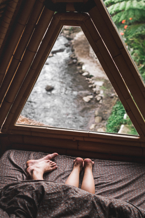Legs of young couple lying in bed together in morning, romantic mood