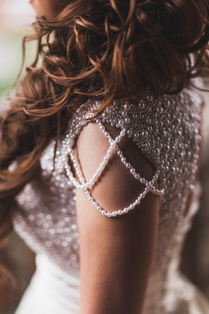 Details of shining wedding dress with pearls and gemstones closeupの写真素材