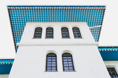White house with blue roof in traditional oriental styleの写真素材