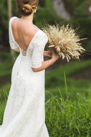 Wedding bouquet with dried flowers and spikelets Boho style in brides handsの写真素材