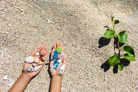 Concept of choice: save nature or continue to use disposable plastic. One hand holding beautiful...